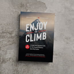 Enjoy the Climb hardcover book by Gregory Cleary and Tom Bouwer on a stone background