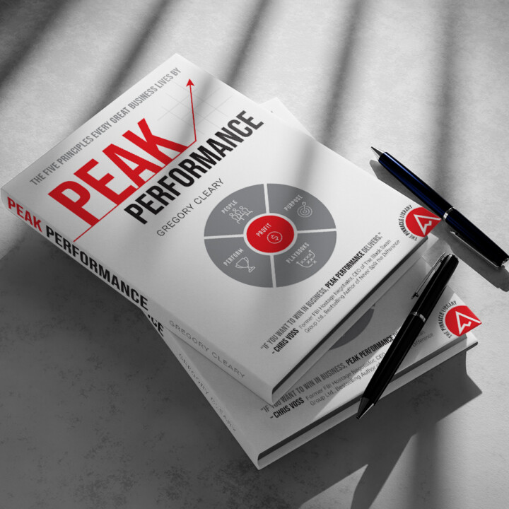 Copies of Peak Performance by Gregory Cleary laid on each other, with pens next to them