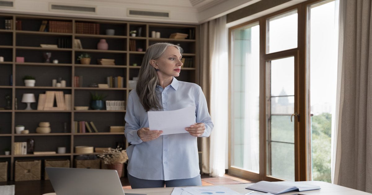 Senior executive at an office window considering a career change
